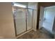 Bathroom showcasing a glass enclosed shower with tile flooring and view to additional room at 168 Bruce Dr, Dunn, NC 28334