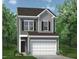 Charming two-story home featuring classic architectural details and lush landscaping at 168 Bruce Dr, Dunn, NC 28334