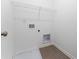 Bright laundry room features essential hookups and a wire shelf for organized storage at 168 Bruce Dr, Dunn, NC 28334