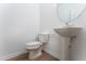 Clean powder room with pedestal sink and modern toilet at 168 Bruce Dr, Dunn, NC 28334