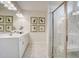 Bright bathroom featuring marble-style floor and shower and white cabinets at 176 Bruce Dr, Dunn, NC 28334