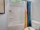 Bathtub and toilet, with a view of the bath and a colorful shower curtain at 176 Bruce Dr, Dunn, NC 28334