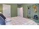 Calm bedroom with multiple doors and practical wall-mounted storage at 176 Bruce Dr, Dunn, NC 28334