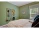 Neutral bedroom with organized wall storage and a pleasant window view at 176 Bruce Dr, Dunn, NC 28334