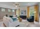Comfortable living room featuring modern furnishings, hardwood floors, and sunlit windows at 176 Bruce Dr, Dunn, NC 28334