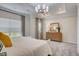 Bright main bedroom with a dresser, mirror and decorative chandelier at 176 Bruce Dr, Dunn, NC 28334