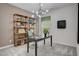 Modern office space with a stylish desk, shelving unit, and contemporary lighting fixture at 176 Bruce Dr, Dunn, NC 28334
