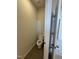 Powder room featuring toilet, tile floors, and neutral color palette at 176 Bruce Dr, Dunn, NC 28334