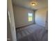 Bedroom with neutral walls and carpet and a single window for natural light at 176 Bruce Dr, Dunn, NC 28334