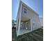 Shows the home's back patio, siding, windows, and lawn in the backyard of the home at 176 Bruce Dr, Dunn, NC 28334