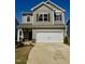 Charming two-story home featuring a two-car garage and neutral-toned siding at 176 Bruce Dr, Dunn, NC 28334