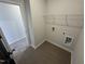 Laundry room has wood-look tile flooring, a wire shelf, and washer/dryer hookups at 176 Bruce Dr, Dunn, NC 28334