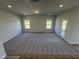 Spacious living room featuring neutral-toned carpet, recessed lighting, and natural light at 176 Bruce Dr, Dunn, NC 28334