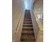 Carpeted stairs lead to the second floor of the home at 176 Bruce Dr, Dunn, NC 28334
