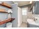 Bathroom with shelves, shower, and tile flooring at 211 W Chisholm St, Sanford, NC 27330