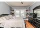 Bedroom featuring hardwood floors, shelves, and a window at 211 W Chisholm St, Sanford, NC 27330