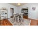Bright dining room with area rug, open to living space, and wood flooring at 211 W Chisholm St, Sanford, NC 27330
