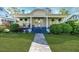 Charming home featuring a lovely front porch, lush landscaping, and inviting curb appeal at 211 W Chisholm St, Sanford, NC 27330