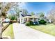 Charming home with a manicured lawn, inviting front porch, and a classic architectural design at 211 W Chisholm St, Sanford, NC 27330