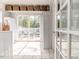 Well-lit laundry room leading to an outdoor deck with a seating area, perfect for relaxation at 211 W Chisholm St, Sanford, NC 27330