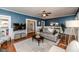 Spacious living room featuring hardwood floors, a ceiling fan, and stylish furnishings at 211 W Chisholm St, Sanford, NC 27330