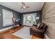 Cozy living room features hardwood floors, a leather couch, and a door leading to the outside at 211 W Chisholm St, Sanford, NC 27330