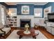 Cozy living room with fireplace, built-in shelves, and charming decor at 211 W Chisholm St, Sanford, NC 27330