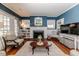 Inviting living room with a fireplace, hardwood floors, and bright natural light at 211 W Chisholm St, Sanford, NC 27330