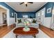 Open-concept living room featuring hardwood floors, neutral furniture, and stylish decor at 211 W Chisholm St, Sanford, NC 27330