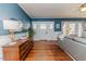 Comfortable living room with hardwood floors, a classic dresser, and neutral decor at 211 W Chisholm St, Sanford, NC 27330