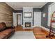 Comfortable living room with painted walls, wooden wall paneling, hardwood floors, and a fireplace at 211 W Chisholm St, Sanford, NC 27330