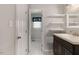 Bathroom featuring tile flooring, sink with vanity, mirror, shelving and open doorway to a bedroom at 227 Coley Farm Rd, Fuquay Varina, NC 27526