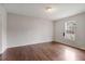 A well-lit bedroom with hardwood flooring, neutral paint, a window, and baseboard trim at 227 Coley Farm Rd, Fuquay Varina, NC 27526