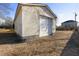 Exterior of a detached garage with a white garage door is surrounded by a wooden fence at 227 Coley Farm Rd, Fuquay Varina, NC 27526