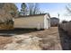 A detached two-car garage with an entry door on a lot surrounded by a wooden fence at 227 Coley Farm Rd, Fuquay Varina, NC 27526