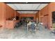 Large garage with orange walls and concrete floor at 227 Coley Farm Rd, Fuquay Varina, NC 27526