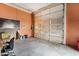 Large garage with orange walls and concrete floor at 227 Coley Farm Rd, Fuquay Varina, NC 27526