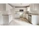 Kitchen featuring light tile floors, white cabinets, stainless steel dishwasher and granite countertops at 227 Coley Farm Rd, Fuquay Varina, NC 27526