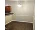 Dining area featuring contemporary light fixture, dark wood-style floor, and chair rail at 2631 Oldgate Dr # 101, Raleigh, NC 27604