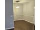 Dining room with wood-look floors, modern light fixture, and wainscoting at 2631 Oldgate Dr # 101, Raleigh, NC 27604