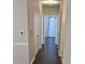Hallway with updated paint, wood-look floor and a decorative light fixture at 2631 Oldgate Dr # 101, Raleigh, NC 27604