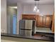 Well-lit kitchen featuring stainless steel appliances, dark countertops, and unique pendant lighting at 2631 Oldgate Dr # 101, Raleigh, NC 27604