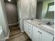 Bright bathroom featuring a double vanity with granite countertop and modern fixtures at 279 Constellation Ct, Benson, NC 27504
