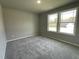 Cozy bedroom featuring soft carpeting, neutral walls and a view of a rear yard and green space at 279 Constellation Ct, Benson, NC 27504