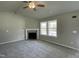 Bright living room featuring a fireplace, neutral carpet, and large windows that provide ample natural light at 279 Constellation Ct, Benson, NC 27504