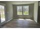 Bright living space with light, wood-look flooring, a rear door and a large window with rear yard views at 279 Constellation Ct, Benson, NC 27504