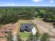 Expansive lot with a new home featuring a dark roof, complemented by mature trees and a long driveway at 2809 Theresa Eileen Way, Raleigh, NC 27603