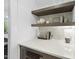 Chic bar area features a quartz countertop, marble backsplash, and stylish decor at 2809 Theresa Eileen Way, Raleigh, NC 27603