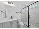Bright bathroom featuring gray cabinets, modern fixtures, and a glass enclosed shower at 2809 Theresa Eileen Way, Raleigh, NC 27603