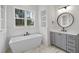 Modern bathroom featuring a soaking tub, marble floors, and a vanity with storage at 2809 Theresa Eileen Way, Raleigh, NC 27603